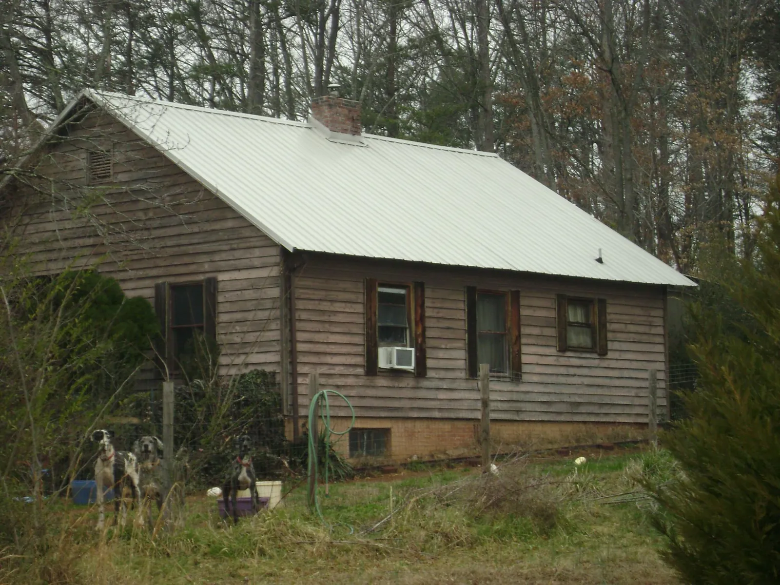 White metal roof on an old wood sided farmhouse, from a Metal Roof Installation job in Lavalette